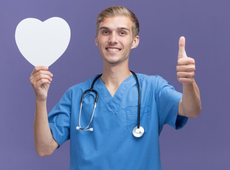 smiling young male doctor wearing doctor uniform with stethoscope holding heart shape box showing thumb up isolated blue wall This picture expresses benefits of gratitude for health